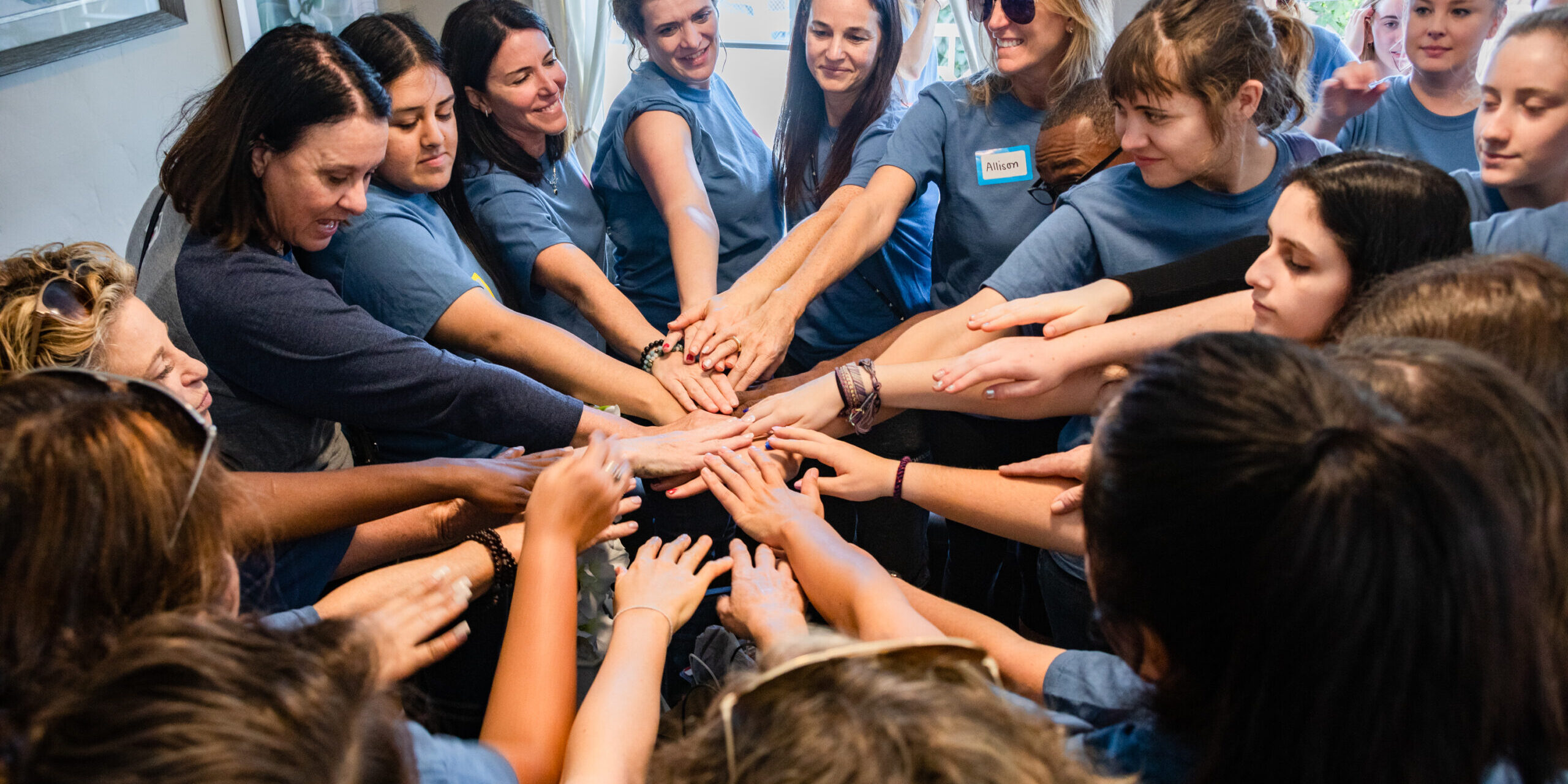 SAM Initiative members with hands in a circle