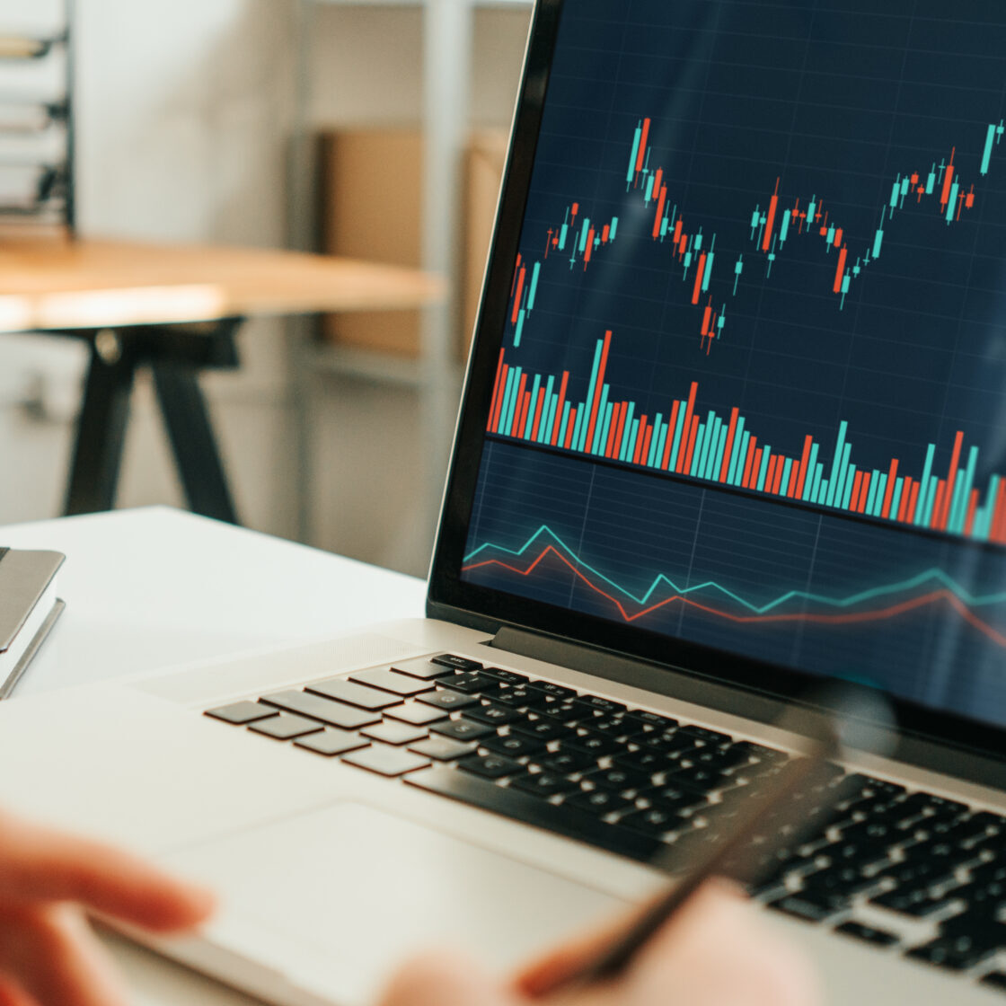 Woman working with investment stock market using laptop, analyzing trading data